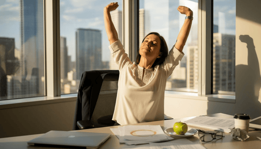 Woman stretching while working in sunny office