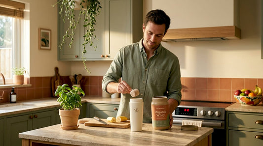 Man preparing whey protein shake in kitchen