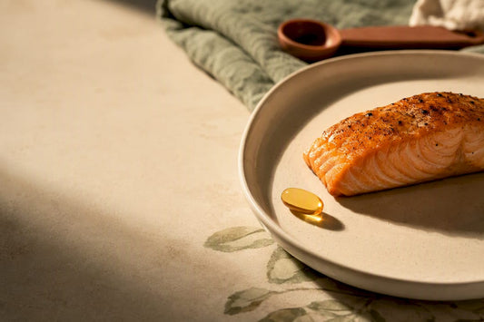 Omega-3 softgel beside salmon portion